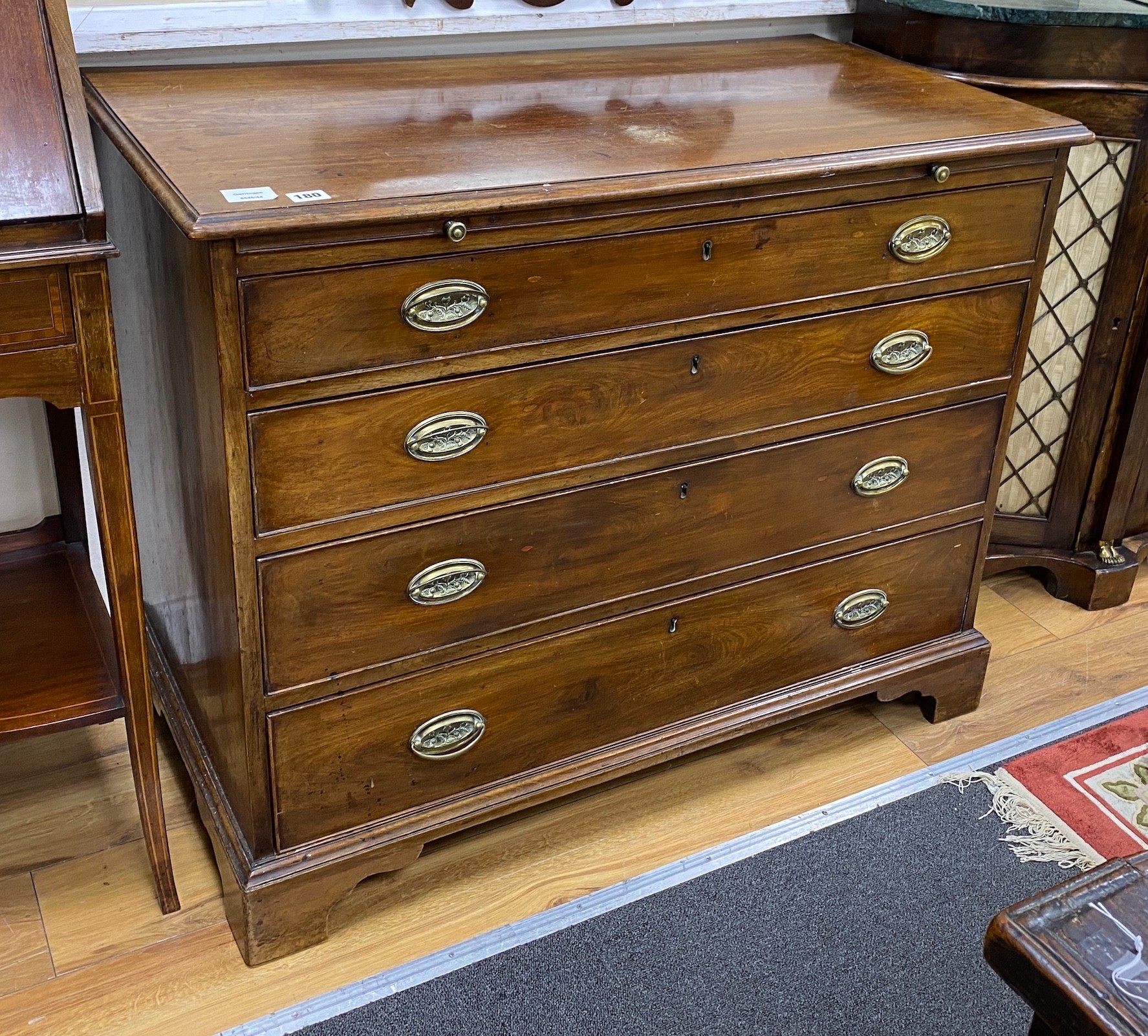 A George III mahogany chest, fitted four long graduated drawers, and brushing slide, width 98cm, depth 52cm, height 79cm